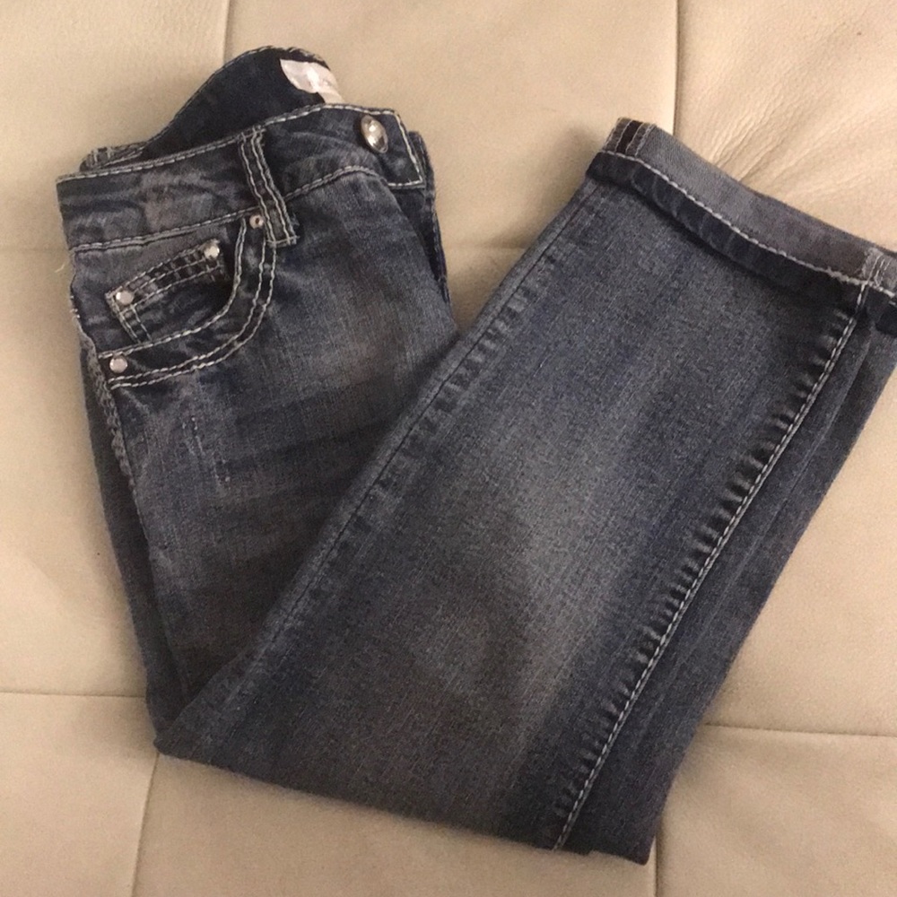 Kids blue jeans with stitching.